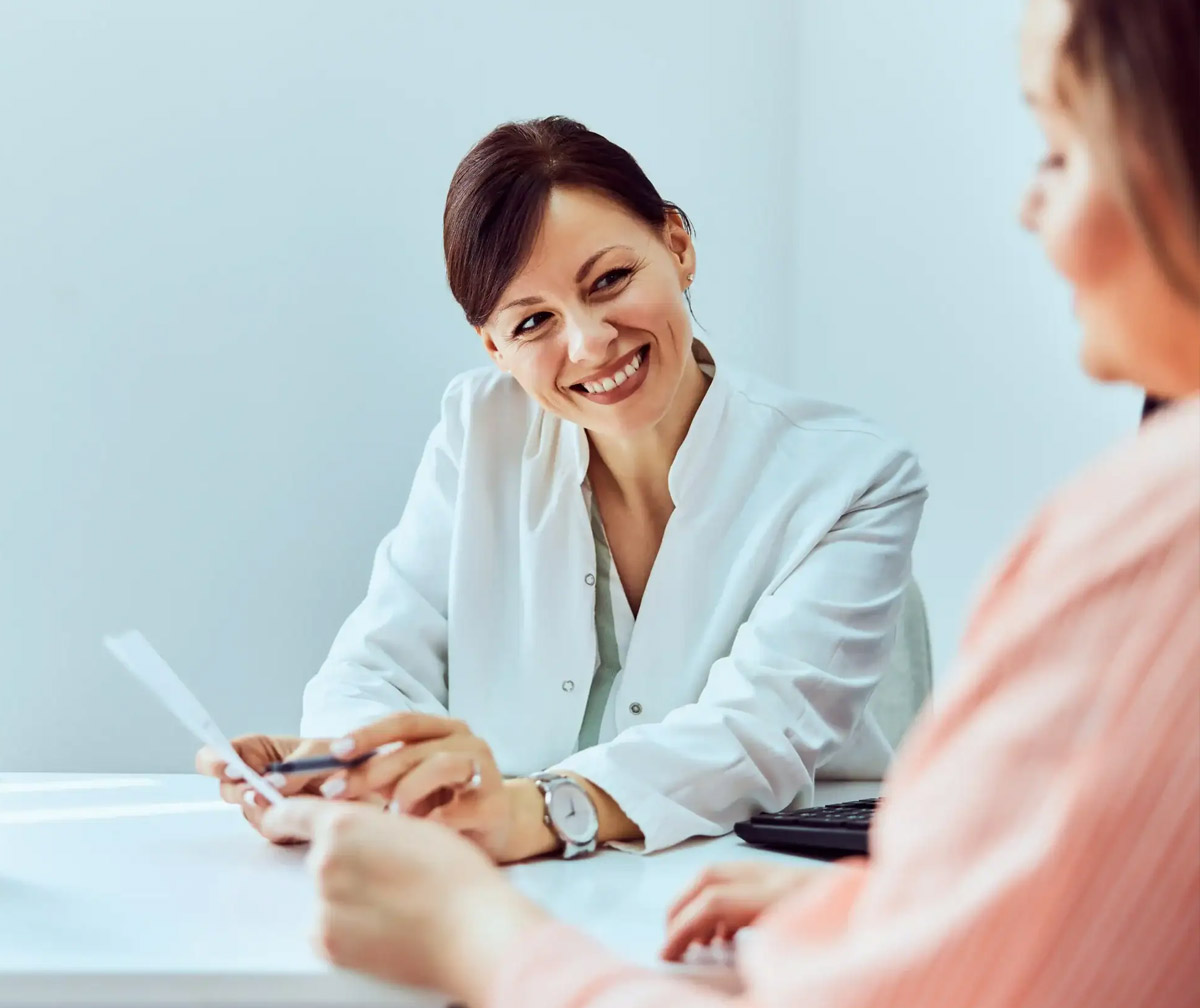 Pharmacist speaking with a patient across the counter